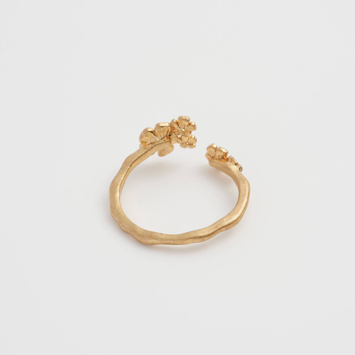 Forget-Me-Not ring close-up showing blue enamel flower cluster on white background
