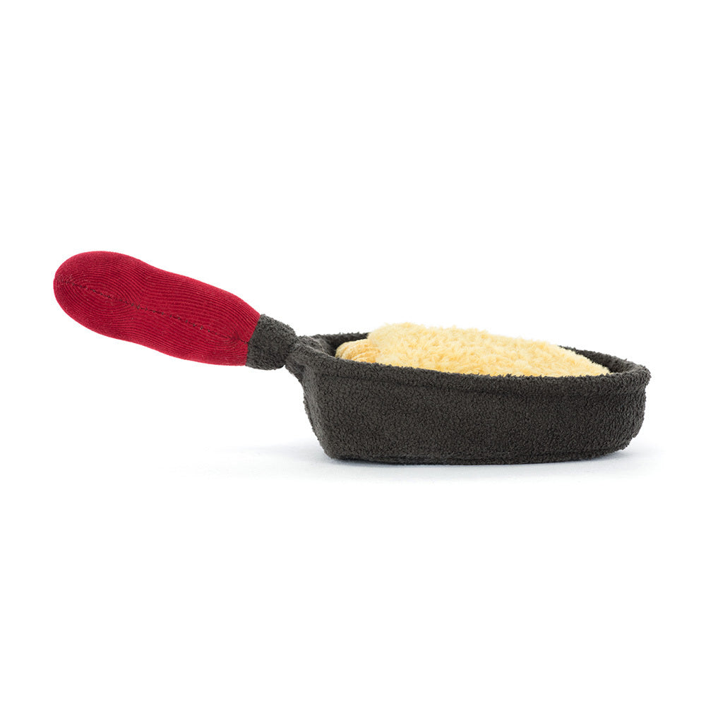 Side profile of Jellycat Amuseables Raclette soft toy showing pan and handle details.