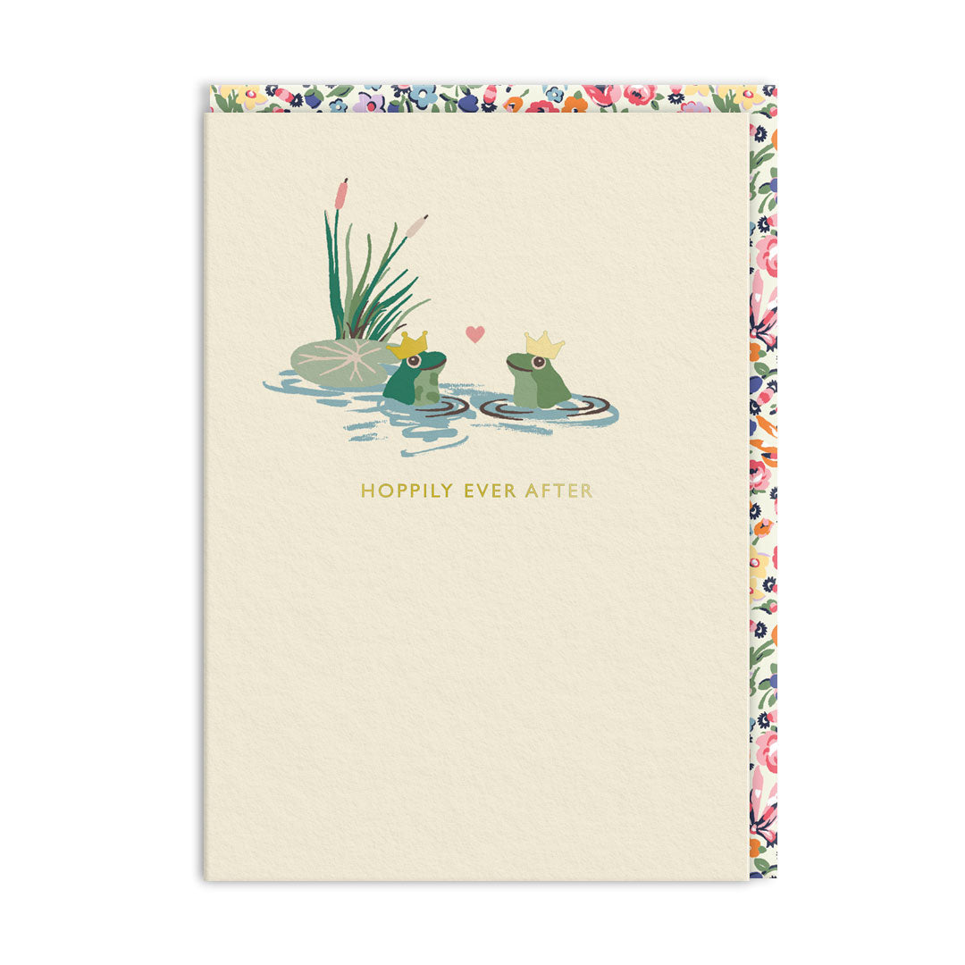 Cream wedding card with two crowned frogs facing each other in a pond