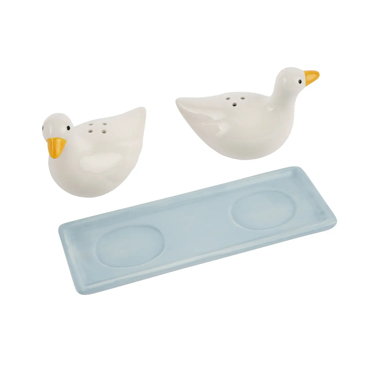 Close-up of ceramic duck shaker heads with visible shaker holes and orange bills, styled on a wooden surface.