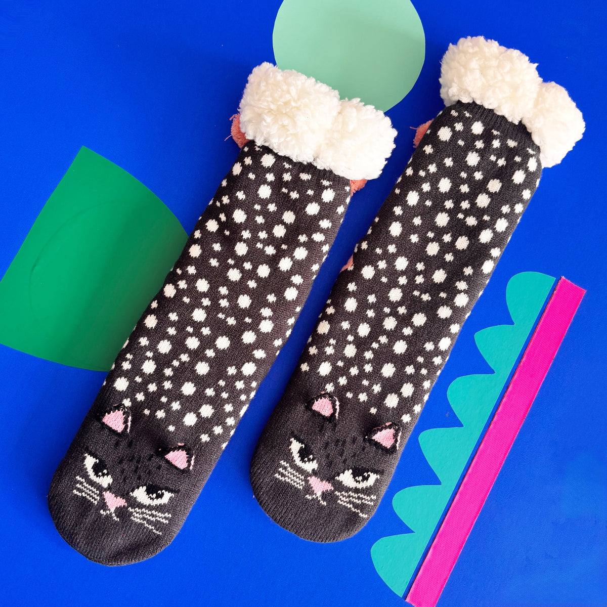 Pair of cat face slipper socks featuring 3D ears and pom poms.