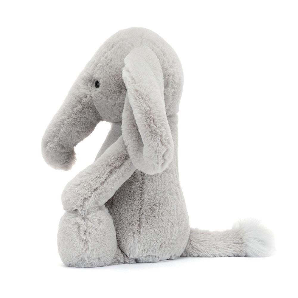 Side profile of Jellycat Bashful Luxe Elephant Thuddeus showing floppy limbs, curved trunk, and soft textured fabric.