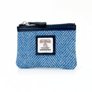 Angled front shot of Harris Tweed sky blue herringbone coin purse.