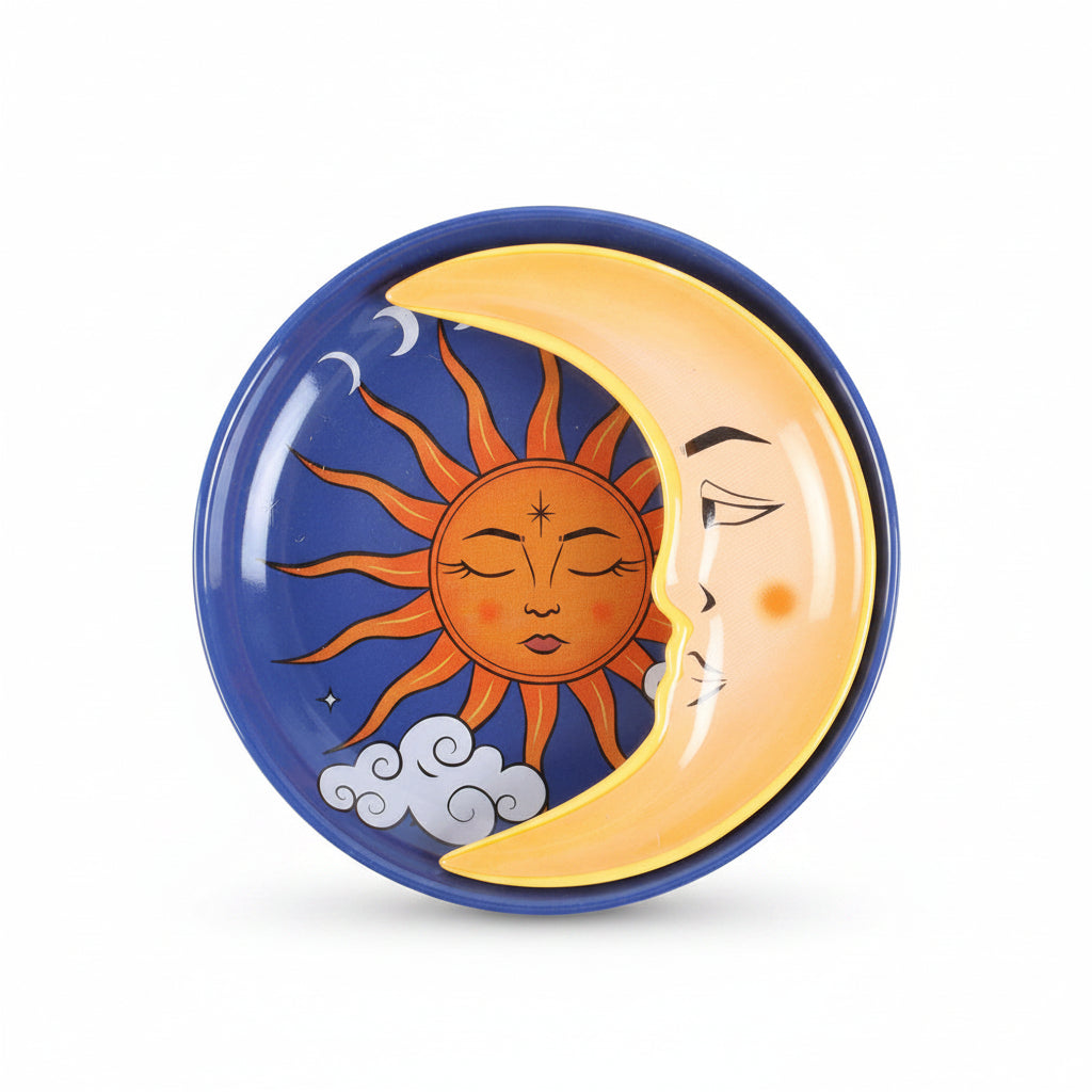 Top-down image of celestial stacking trinket dish with crescent moon overlaying sun illustration on blue circular base with cloud and moon phase details.