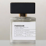 Parisian eau de parfum bottle with black cap, front view on cream background