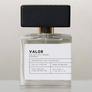 Valor eau de parfum bottle with black cap, front view on cream background