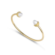 Bill Skinner Acorn and Oak Bangle, open gold cuff with pearl acorn ends, on white