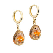 Bill Skinner Hedgehog and Pumpkin Huggie Earrings, gold hoops with enamel charms, on white
