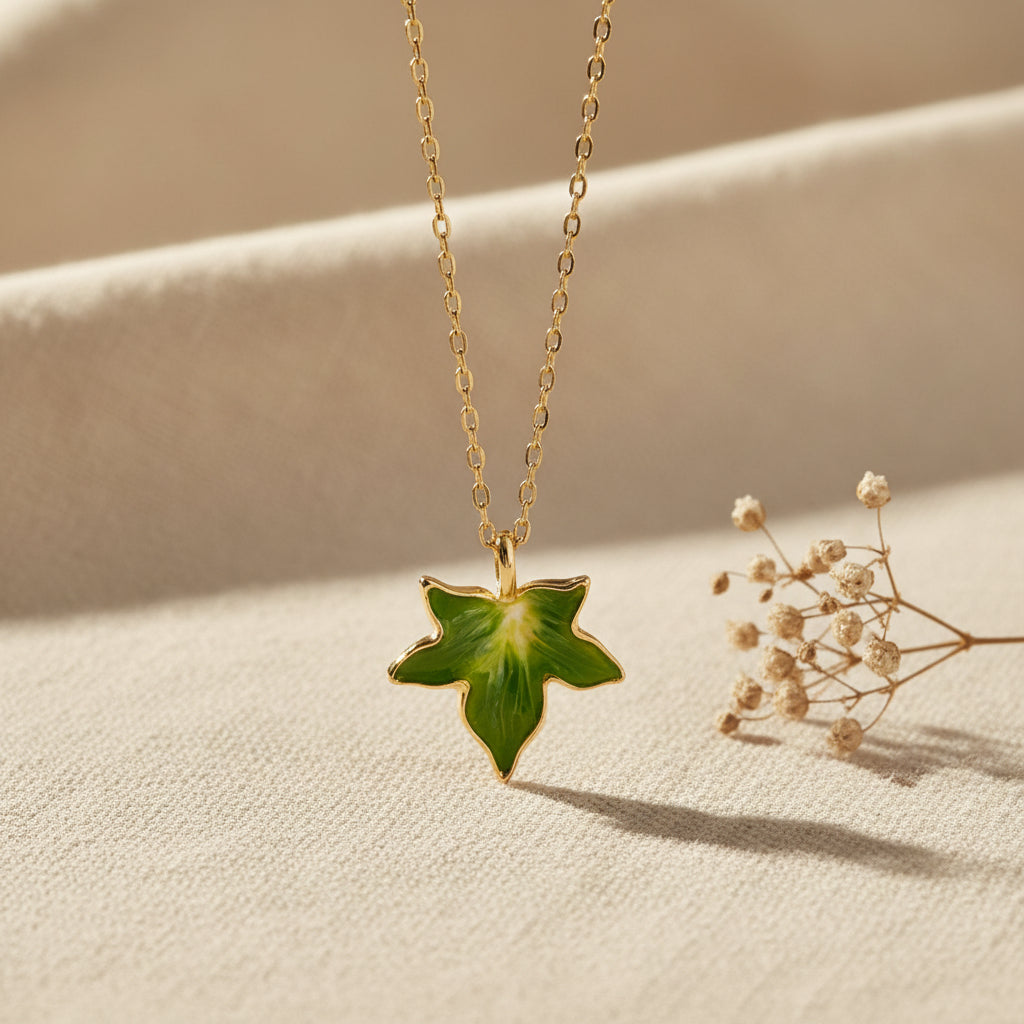 Bill Skinner Ivy Pendant, green leaf on a fine gold chain, on white