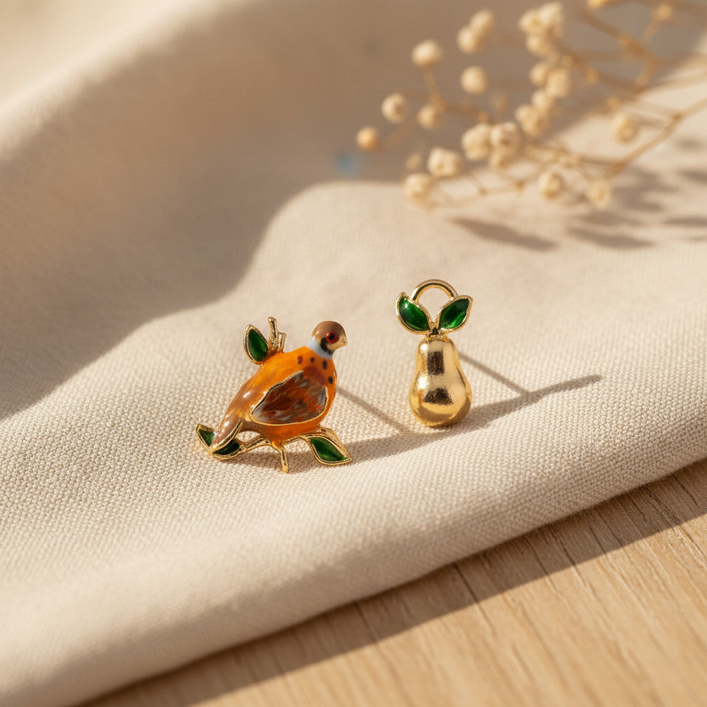 Bill Skinner Partridge and Pear Mismatch Stud Earrings, enamel partridge and gold pear, on white