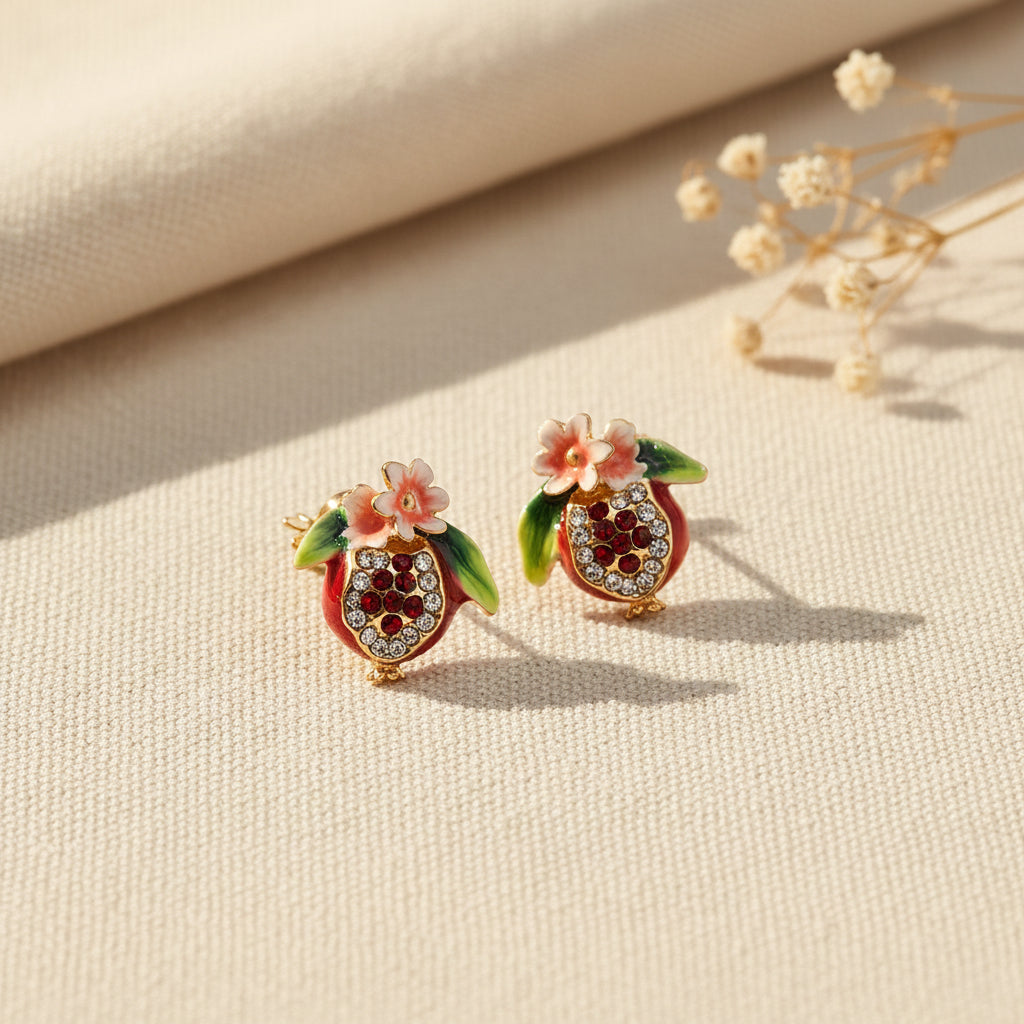 Bill Skinner Pomegranate Stud Earrings, jewelled red pomegranates with pink blossom, on white