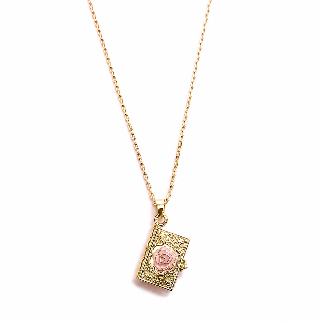 Bill Skinner Rose Book Locket, gold book pendant with a pink enamel rose, on white