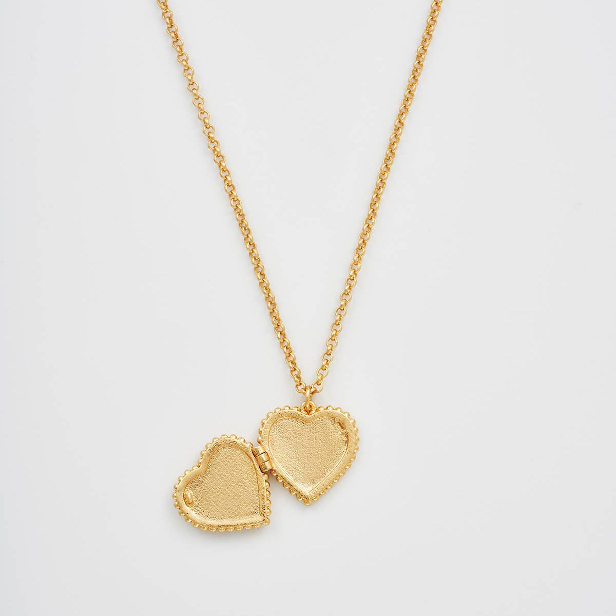 Jasmine Heart Locket Necklace open, showing the inside photo space of the heart locket.
