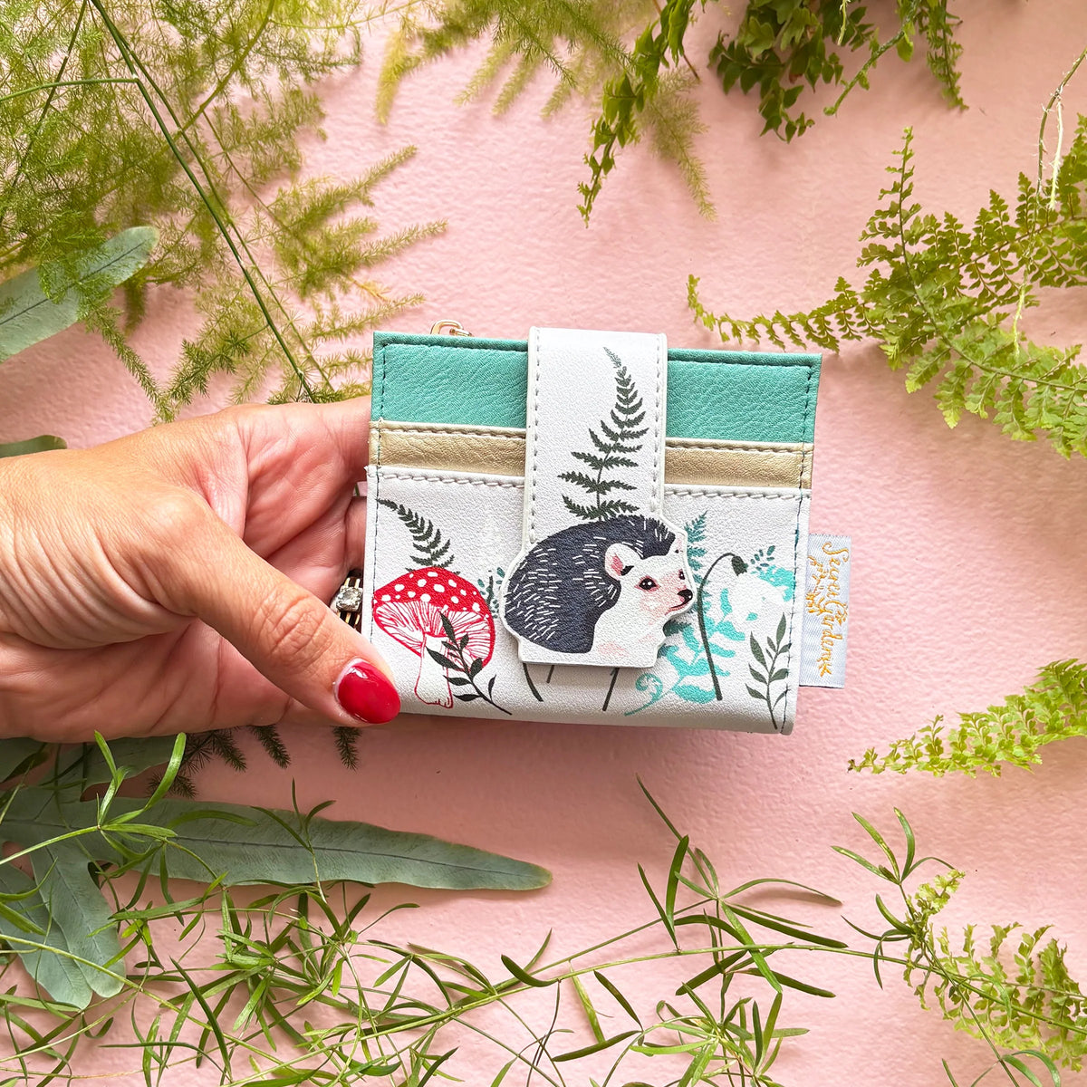 Hedgehog purse held in hand showing compact size