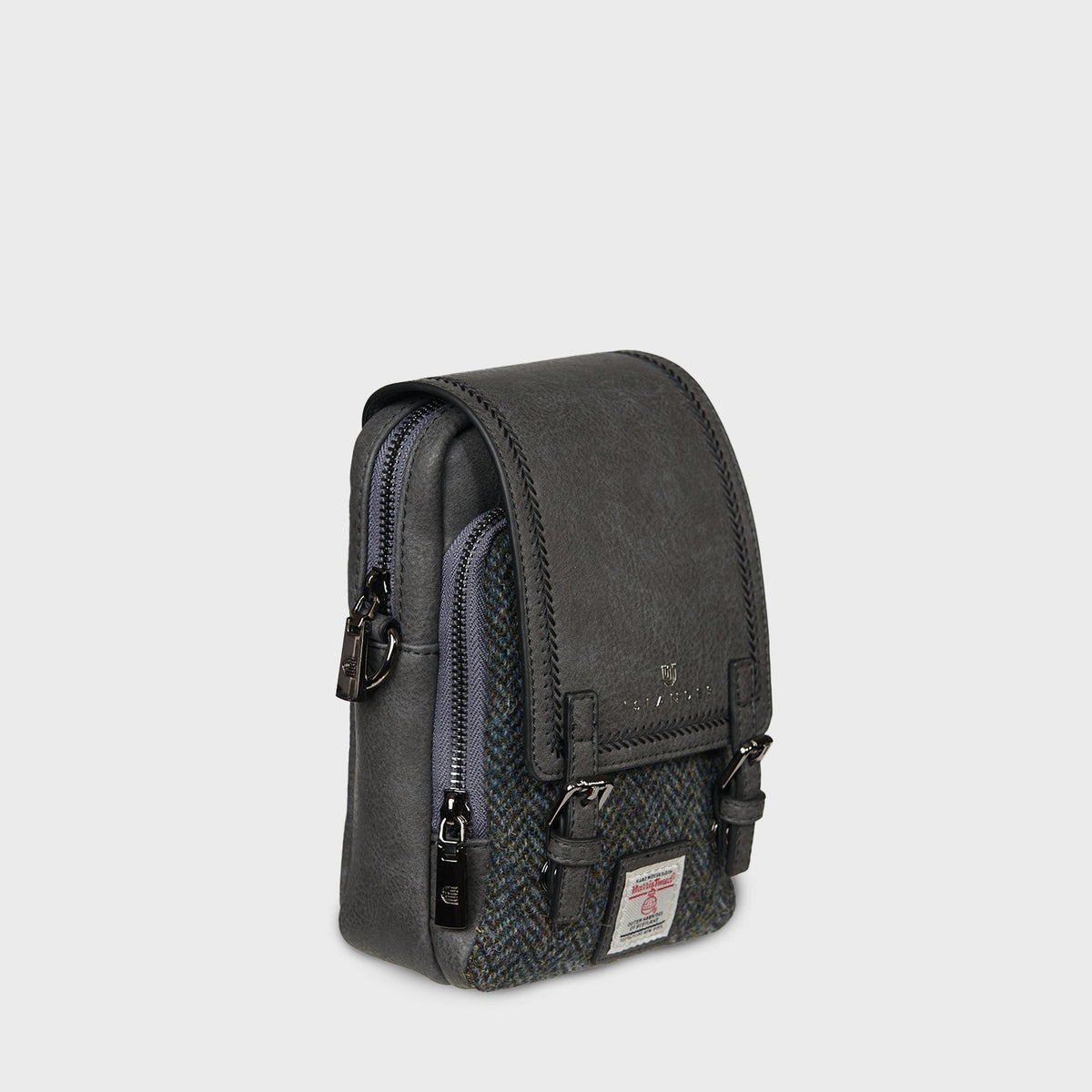 Side of the black Baby Jura crossbody showing the zip and strap clip