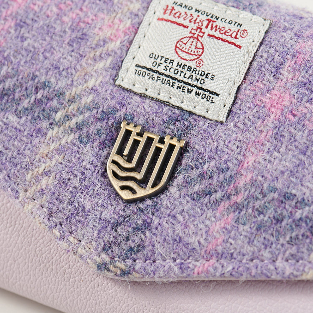 Close up of the Harris Tweed orb label and brass Islander badge