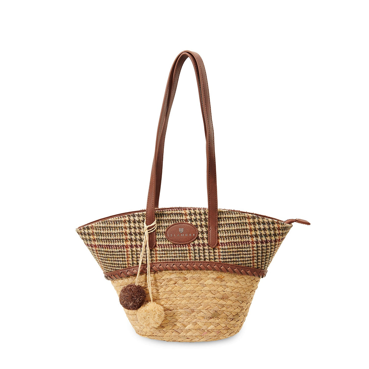Beige dogtooth straw basket bag with a wool pom pom charm on the handle