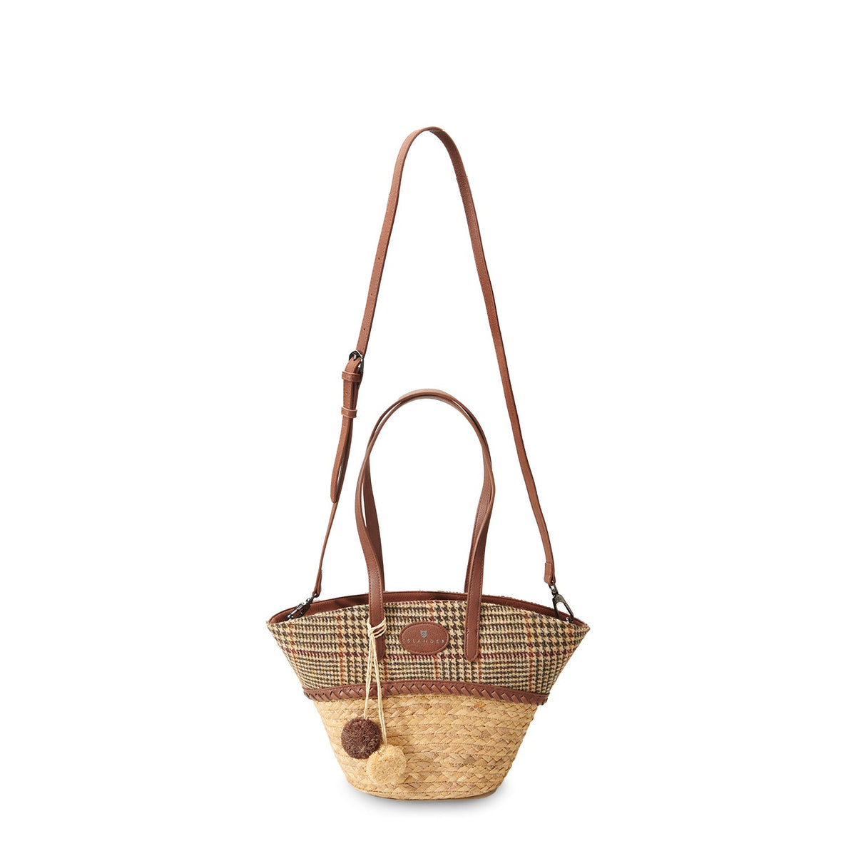 Beige dogtooth basket bag shown with the long adjustable shoulder strap