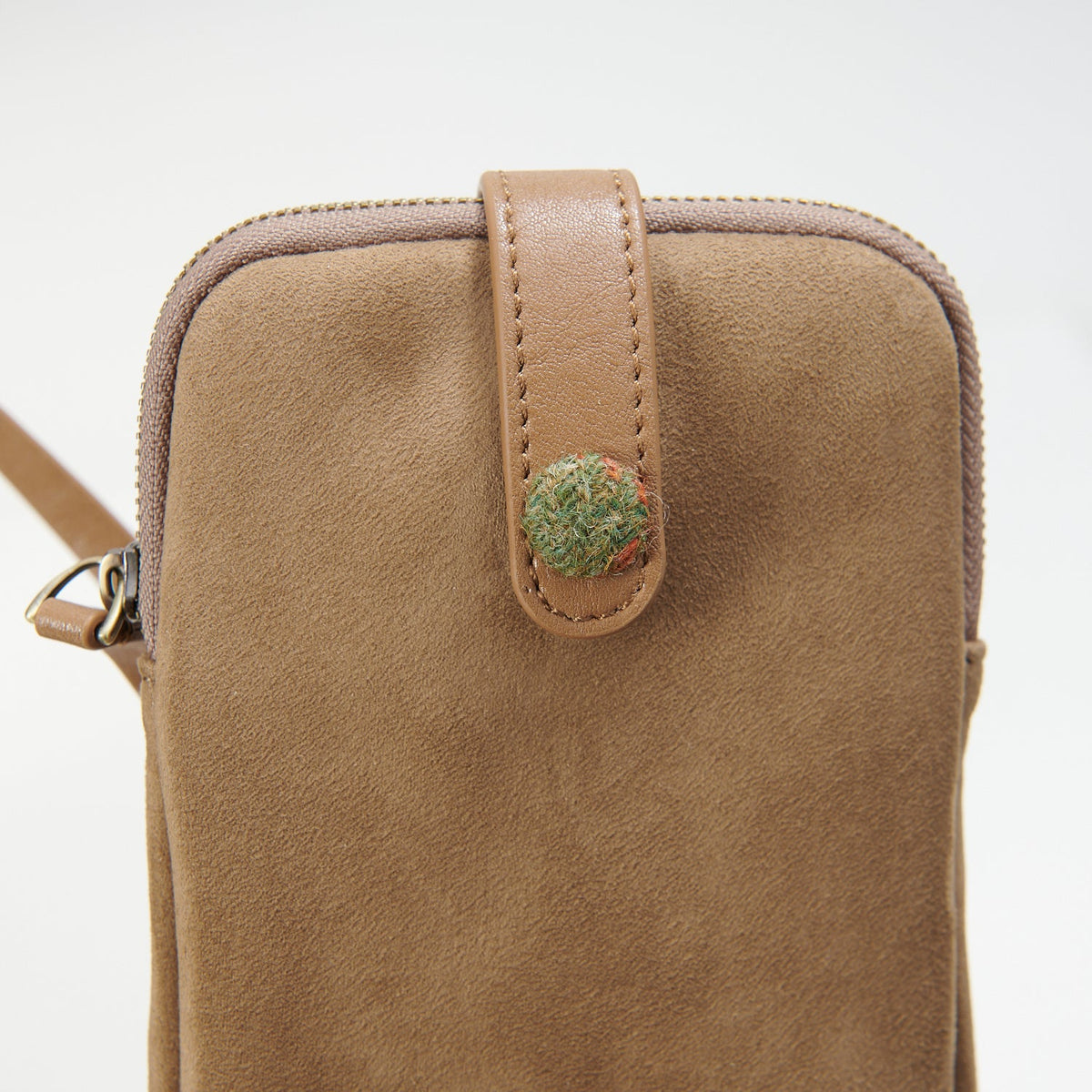 Islander phone pouch close-up showing suede texture and tartan detail