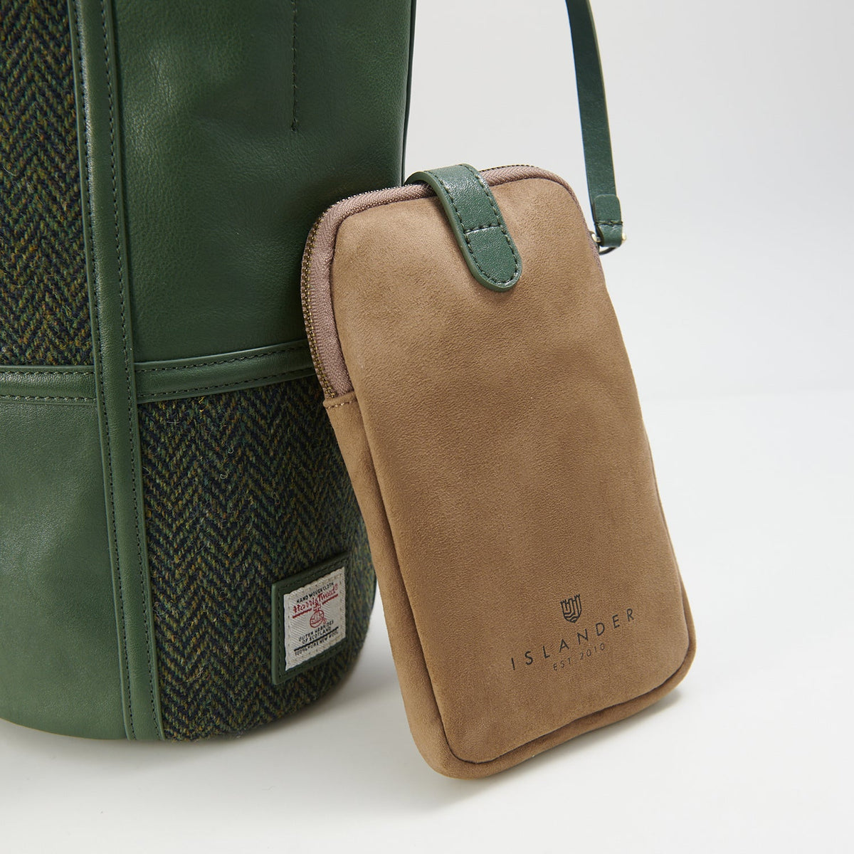 Green herringbone bucket bag side view with phone pouch on white background