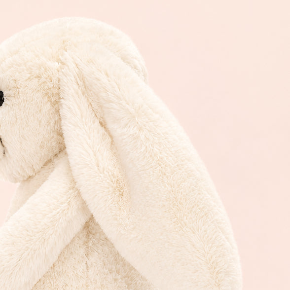 White plush bunny toy on a white background