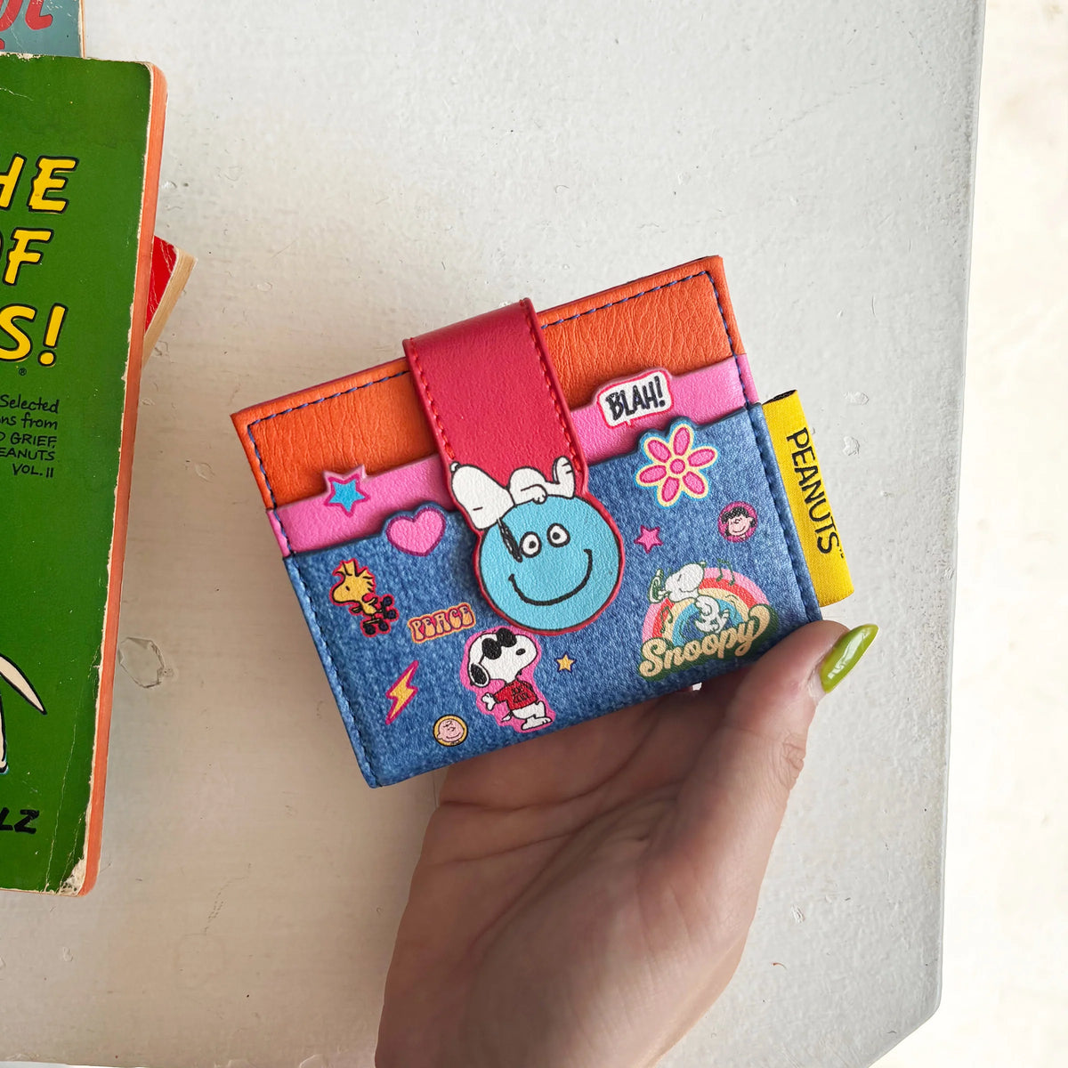 Peanuts patch wallet held in hand