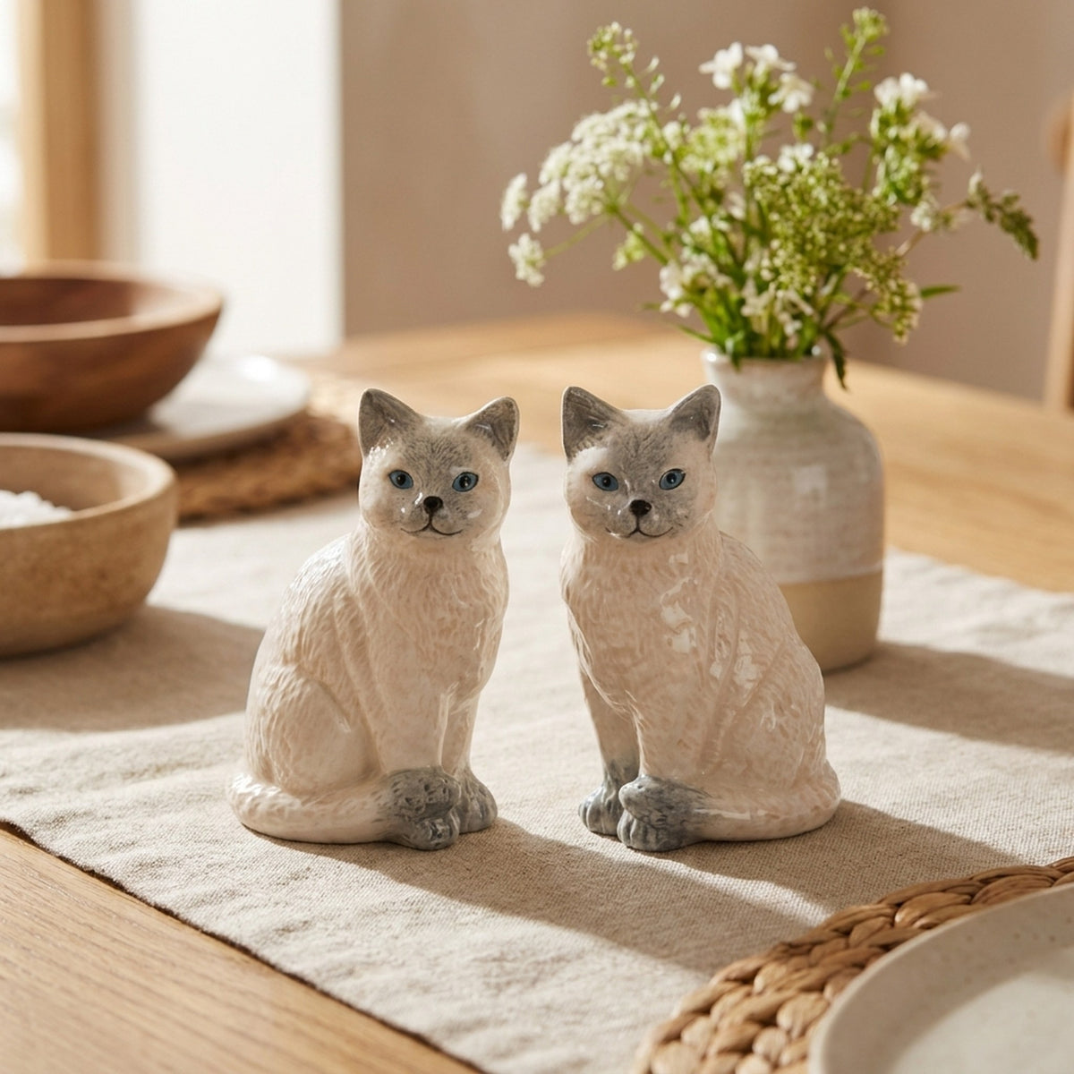Ragdoll Cat Salt and Pepper Shakers on a dining table with flowers