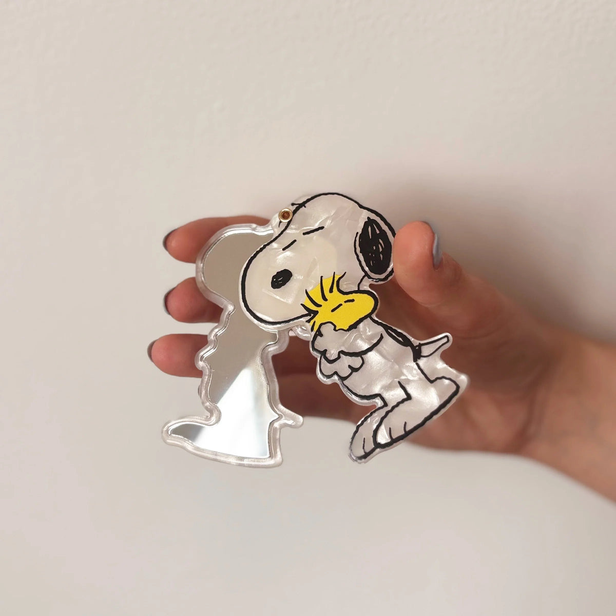 Peanuts Snoopy and Woodstock compact mirror opened and held in hand.
