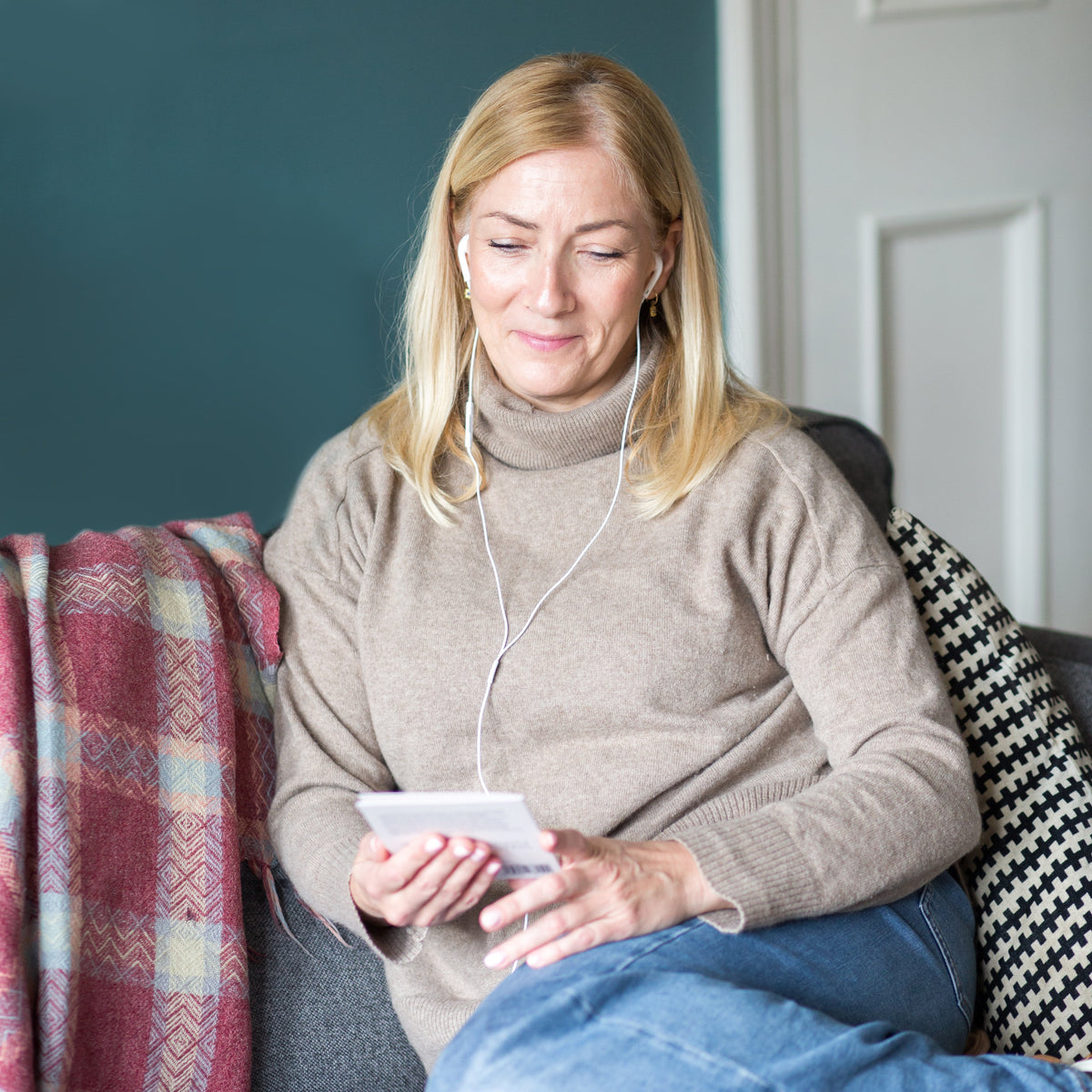 Woman listening to a Spiracle audiobook through headphones